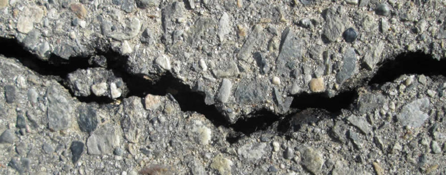 cracked asphalt up close: Bethesda driveway repair