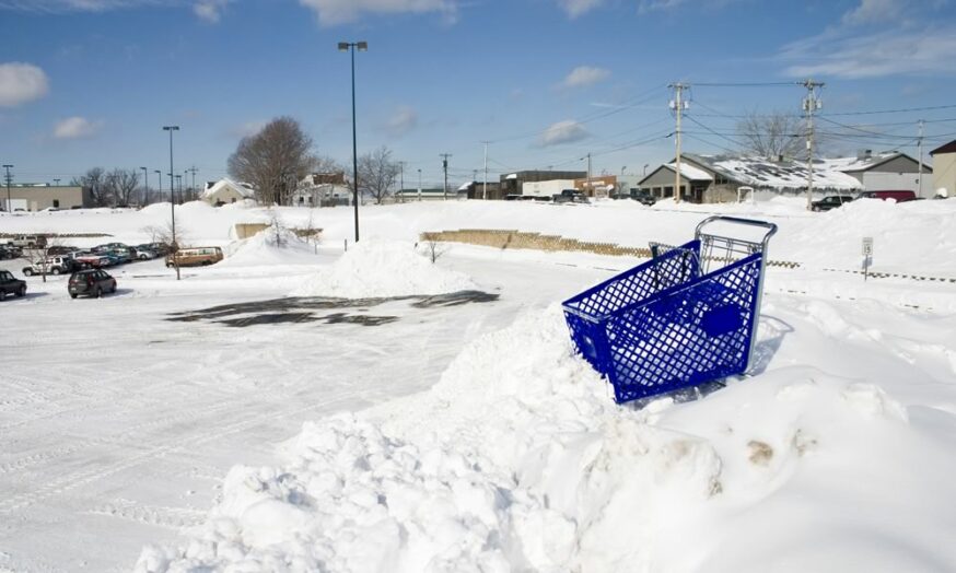 shopping cart stuck in a snow pile